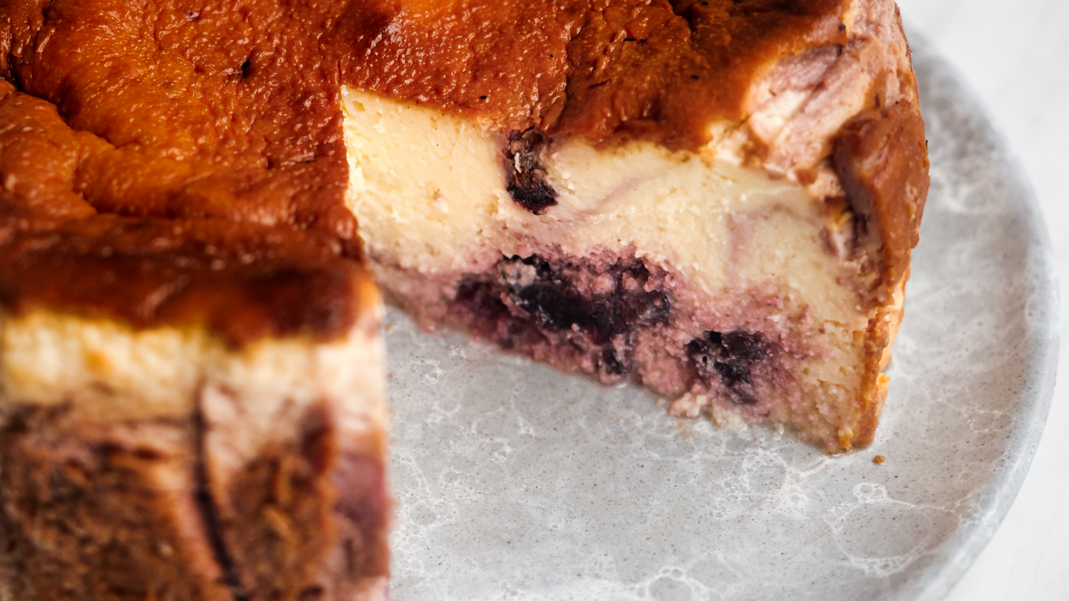 Basque cheesecake with a slice cut out of it