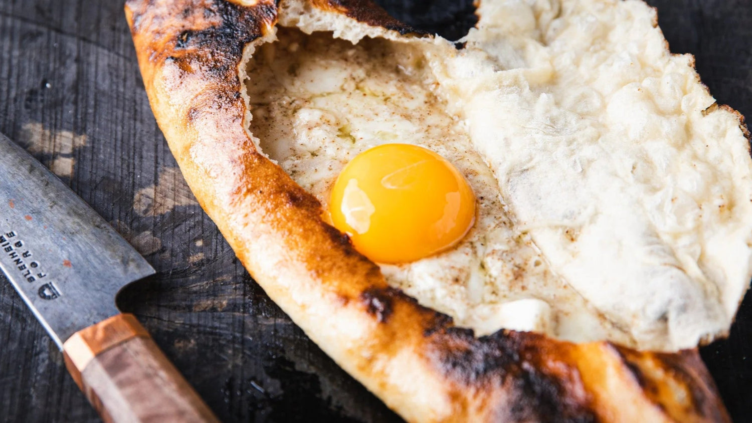 Cheese pide next to knife