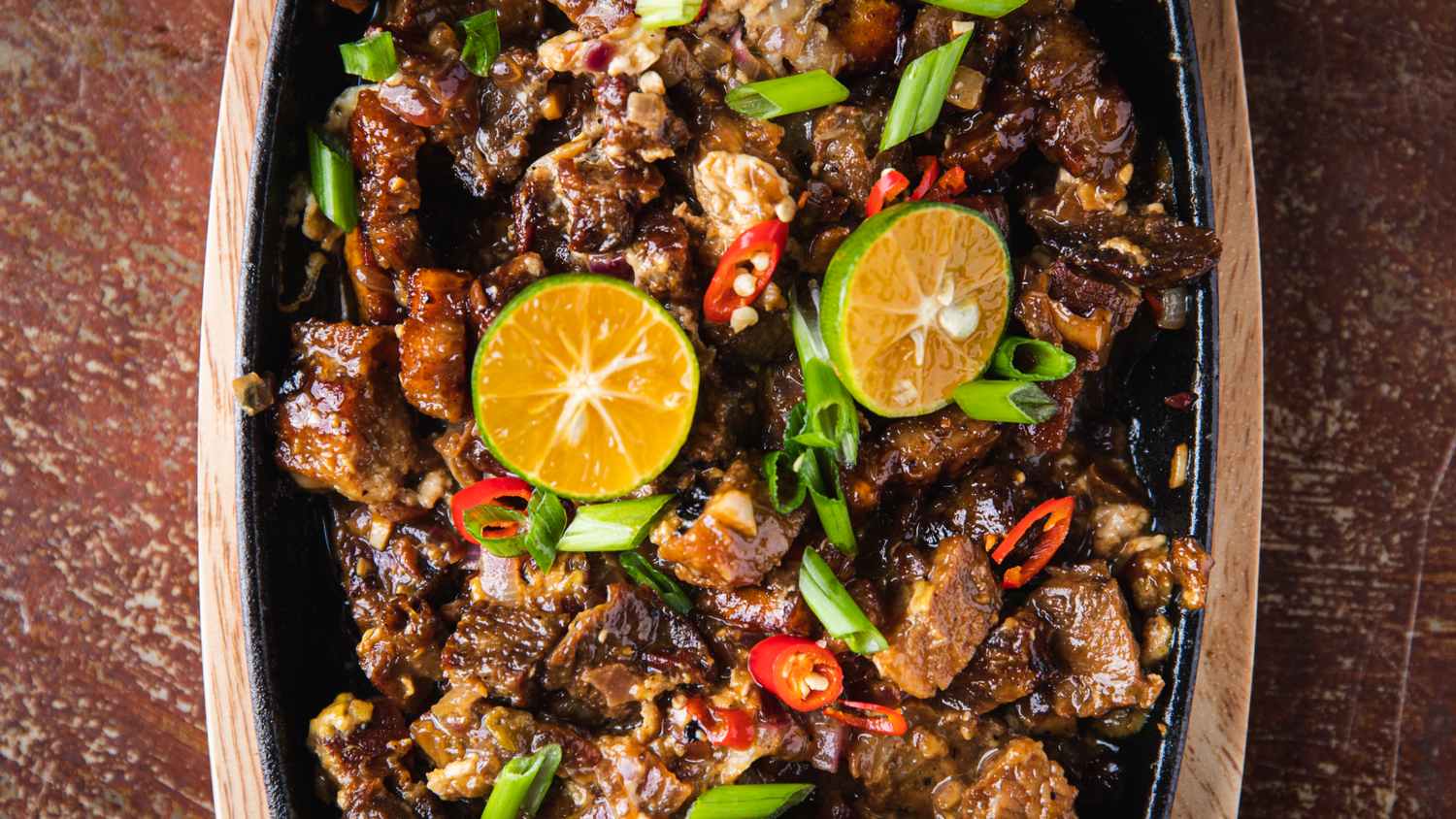 Pork Belly Sisig served on hot skillet