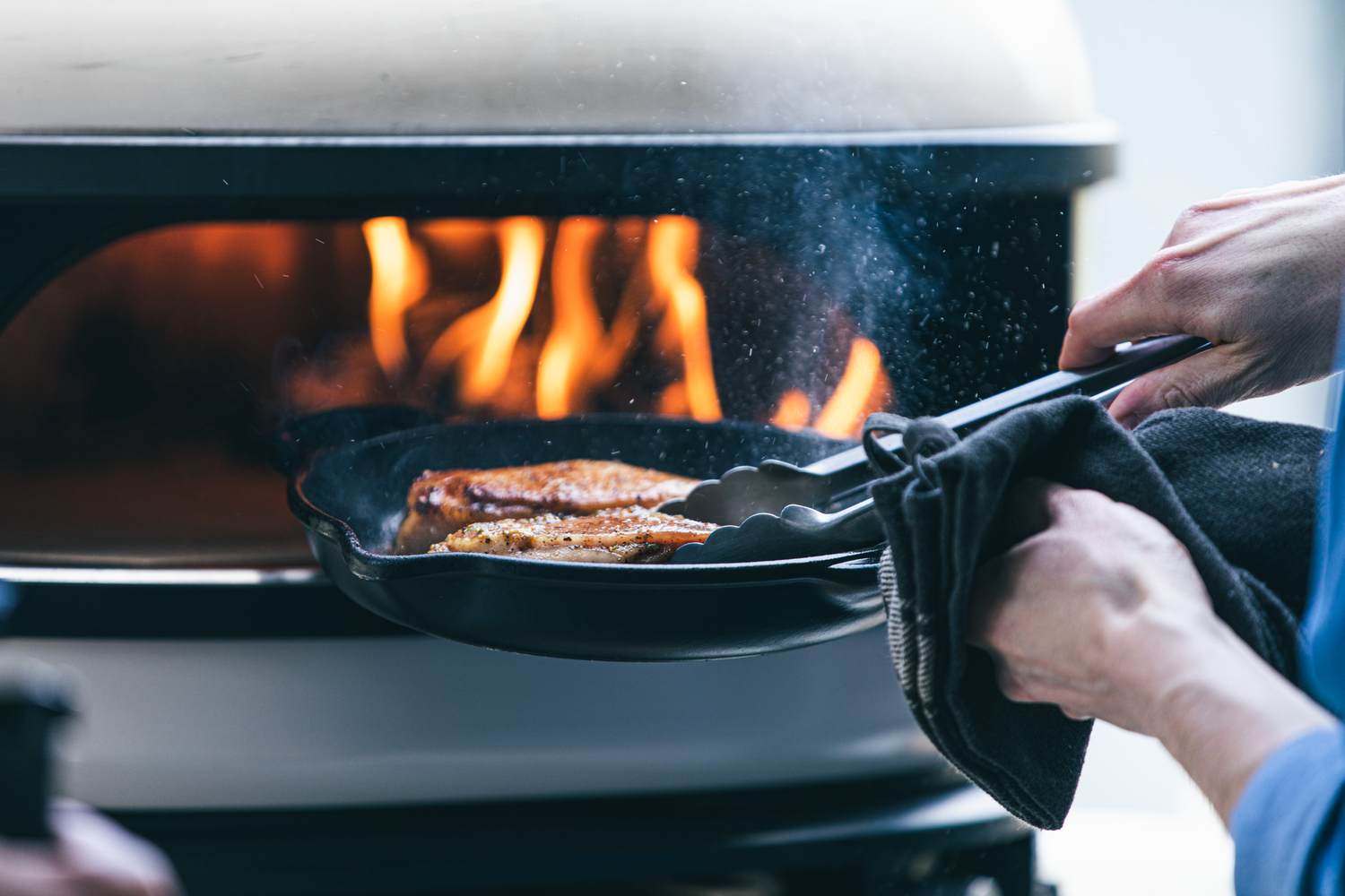 Pork Chop placed into Gozney Oven in cast iron pan
